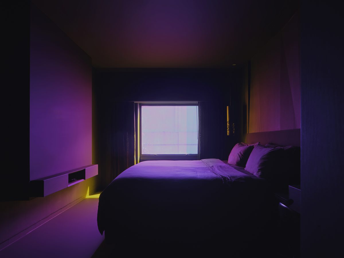The matte-black SLEEP guest room at Naumi Hotel Singapore